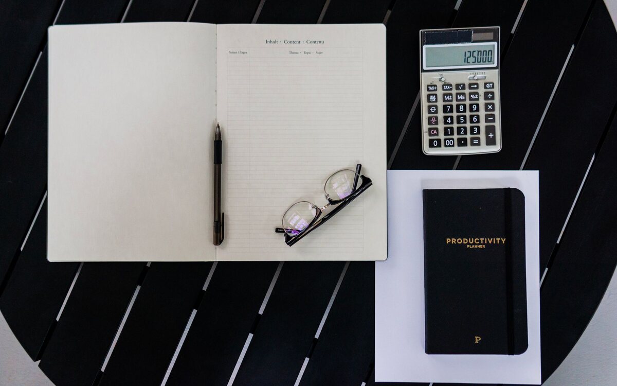 Calculadora e caderno de planejamento sobre a mesa